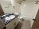 Modern bathroom featuring a marble countertop, sleek black hardware and a tub with tile surround at 56 S Nome St, Aurora, CO 80012