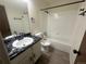 Modern bathroom featuring a marble countertop, sleek black hardware and a tub with tile surround at 56 S Nome St, Aurora, CO 80012