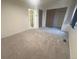 Spacious bedroom with neutral paint, plush carpeting, and two closets with sliding doors at 56 S Nome St, Aurora, CO 80012