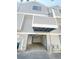 Exterior shot of a gray two-story condo building showing the garage and unit number 56 at 56 S Nome St, Aurora, CO 80012