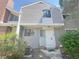 Exterior of a gray two-story condo with unit number 56, showing landscaping and a pathway to the front door at 56 S Nome St, Aurora, CO 80012
