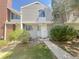 Exterior of a gray two-story condo with unit number 56 and landscaping around the front entrance at 56 S Nome St, Aurora, CO 80012
