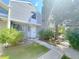Charming two-story townhome with newly installed gray siding and a lush green landscaped front yard at 56 S Nome St, Aurora, CO 80012