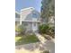 Charming two-story townhome with newly installed gray siding, manicured landscaping, and a welcoming front walkway at 56 S Nome St, Aurora, CO 80012