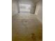 View of the concrete floor in an attached garage with white walls leading to an exterior parking area at 56 S Nome St, Aurora, CO 80012