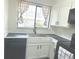 Bright kitchen featuring stainless steel sink, sleek black countertops and modern black hardware at 56 S Nome St, Aurora, CO 80012