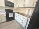 Spacious kitchen featuring modern appliances, bright white cabinets, and wood-look countertops at 56 S Nome St, Aurora, CO 80012