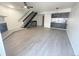 Bright living room features modern floors, fireplace, adjacent stairway, and a sleek breakfast bar at 56 S Nome St, Aurora, CO 80012