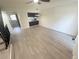 Bright living room features modern floors, adjacent stairway, and a sleek breakfast bar in an open layout at 56 S Nome St, Aurora, CO 80012