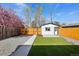 Landscaped backyard featuring lawn, gravel and walkway leading to the detached garage at 1209 Harrison St, Denver, CO 80206