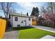 Rear exterior of the property featuring green lawn, gravel and walkway leading to the house at 1209 Harrison St, Denver, CO 80206