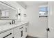 Modern bathroom featuring vanity with marble countertop, a large mirror, and black hardware at 1209 Harrison St, Denver, CO 80206