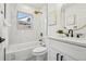 Contemporary bathroom with a soaking tub, marble tile, and gold fixtures at 1209 Harrison St, Denver, CO 80206