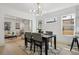 Elegant dining room with modern chandelier, and views into the living room at 1209 Harrison St, Denver, CO 80206