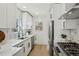 Well-equipped kitchen with stainless steel appliances, white cabinets, and a functional layout for cooking at 1209 Harrison St, Denver, CO 80206