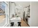 Bright kitchen with white cabinetry, stainless steel appliances, and a breakfast bar with seating for two at 1209 Harrison St, Denver, CO 80206