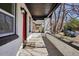 Inviting covered front porch with brick pillars and a 'Welcome' mat, adding character to the entrance at 1209 Harrison St, Denver, CO 80206