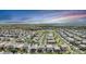 Wide aerial photograph displaying a community with numerous houses, green spaces, and a community park at 3453 Pacific Peak Dr, Broomfield, CO 80023