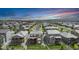 High angle view of a residential area featuring well-maintained lawns and houses, set against a colorful sunset sky at 3453 Pacific Peak Dr, Broomfield, CO 80023