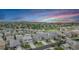 An aerial view of the community showcasing the neatly arranged homes and the picturesque landscape at sunset at 3453 Pacific Peak Dr, Broomfield, CO 80023