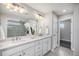 Modern bathroom featuring double sinks, sleek vanity, and glass-enclosed shower enhance the spa-like feel at 3453 Pacific Peak Dr, Broomfield, CO 80023