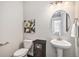 Chic powder room features a pedestal sink, decorative mirror, and stylish wall art that enhances its appeal at 3453 Pacific Peak Dr, Broomfield, CO 80023