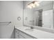 Bathroom featuring a white vanity with a large mirror, and a shower behind a glass door at 3453 Pacific Peak Dr, Broomfield, CO 80023