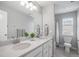 Well-lit bathroom featuring a double sink vanity with white countertops and a separate toilet and shower area at 3453 Pacific Peak Dr, Broomfield, CO 80023