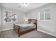 Cozy bedroom with a wood frame bed, soft carpet, and a window view of the neighborhood at 3453 Pacific Peak Dr, Broomfield, CO 80023