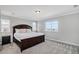 Relaxing bedroom with a dark wood bed frame, soft lighting, and cozy carpet for a tranquil retreat at 3453 Pacific Peak Dr, Broomfield, CO 80023