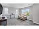 Sunlit bedroom with large windows and comfortable seating makes an ideal space for relaxation and entertainment at 3453 Pacific Peak Dr, Broomfield, CO 80023