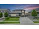 Charming two-story home with gray siding, stone accents, and well-manicured lawn and landscaping at 3453 Pacific Peak Dr, Broomfield, CO 80023