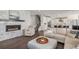Cozy living room with a fireplace, comfortable seating, and an open layout to the modern kitchen at 3453 Pacific Peak Dr, Broomfield, CO 80023