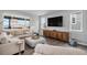 Spacious living room with large windows, modern furnishings, and hardwood floors create a comfortable gathering space at 3453 Pacific Peak Dr, Broomfield, CO 80023