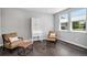 Bright sitting room with wooden floors, a secretary, comfortable seating, and natural light makes a perfect cozy room at 3453 Pacific Peak Dr, Broomfield, CO 80023