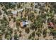 Aerial view of a wooded property featuring a wood home, decks, and a driveway at 7282 Silverhorn Dr, Evergreen, CO 80439