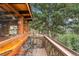 Cabin balcony featuring counter seating with views of the surrounding woodland and mountains at 7282 Silverhorn Dr, Evergreen, CO 80439