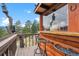 Cabin balcony featuring counter seating with views of the surrounding woodland and mountains at 7282 Silverhorn Dr, Evergreen, CO 80439