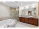 Elegant bathroom with a soaking tub, glass-enclosed shower, and double sink vanity with vessel sinks at 7282 Silverhorn Dr, Evergreen, CO 80439