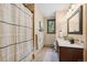 Neutral bathroom with a window, vanity, and a shower featuring a decorative shower curtain at 7282 Silverhorn Dr, Evergreen, CO 80439