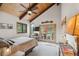 Bedroom with vaulted ceiling, sliding glass doors to balcony and beautiful natural light at 7282 Silverhorn Dr, Evergreen, CO 80439