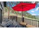 Spacious wooden deck with black railing and seating that overlooks a mountain view at 7282 Silverhorn Dr, Evergreen, CO 80439