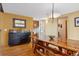 Bright dining room with wood table and benches, dark storage cabinet, and natural lighting at 7282 Silverhorn Dr, Evergreen, CO 80439