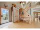 Inviting entryway featuring wood accents, a charming bench, and a glimpse of the beautiful outdoors at 7282 Silverhorn Dr, Evergreen, CO 80439