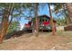 Stunning exterior view of a multi-level home with ample decking and gorgeous landscaping at 7282 Silverhorn Dr, Evergreen, CO 80439