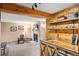 Cozy living room featuring a fireplace and custom wood bar area with sink at 7282 Silverhorn Dr, Evergreen, CO 80439