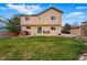Well-maintained backyard features a large grassy area, patio, brick grill, and privacy fence at 4014 S Kirk Way, Aurora, CO 80013