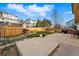 Spacious backyard with a large patio area, grass, grill, and privacy fence at 4014 S Kirk Way, Aurora, CO 80013