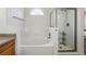Bright bathroom featuring a soaking tub with tiled surround and a separate shower with glass door at 4014 S Kirk Way, Aurora, CO 80013