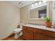 Half bathroom with granite countertop vanity, wood floors, and decorative accents at 4014 S Kirk Way, Aurora, CO 80013